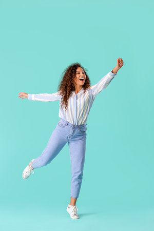 Carefree young woman on color backgroundの写真素材