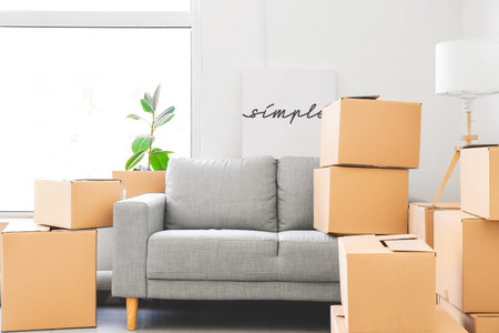 Packed belongings in new flat on moving day