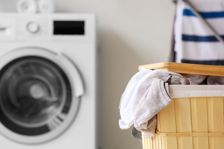Basket with dirty clothes in laundry room, closeupの写真素材