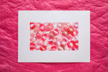 Lipstick kiss marks on color paper sheetsの写真素材