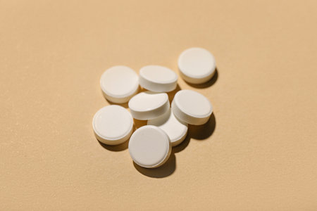 White pills on beige backgroundの写真素材