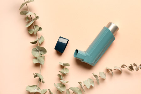 Asthma inhaler with eucalyptus branches on beige backgroundの写真素材