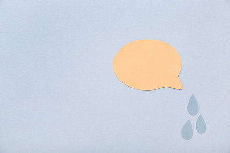 Paper tears with speech bubble on gray background. Dialogue concept