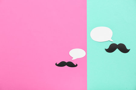 Paper mustaches with speech bubbles on color background. Dialogue conceptの写真素材