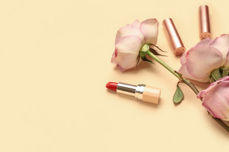 Lipsticks with roses on beige background, closeupの写真素材