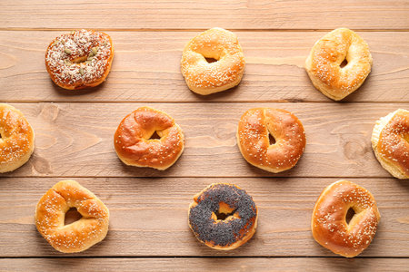 Tasty bagels with sesame and poppy seeds on wooden backgroundの写真素材