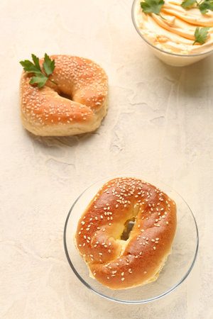 Plate with tasty bagels on light backgroundの写真素材