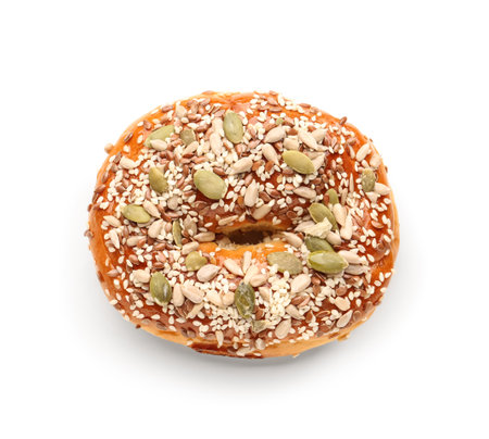 Tasty bagel with sesame and pumpkin seeds on white backgroundの写真素材