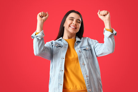 Happy young woman on red backgroundの写真素材