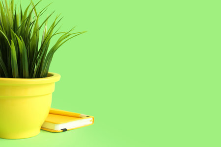 Artificial grass with notebook on green backgroundの写真素材