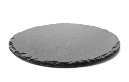 Round slate board isolated on white backgroundの写真素材