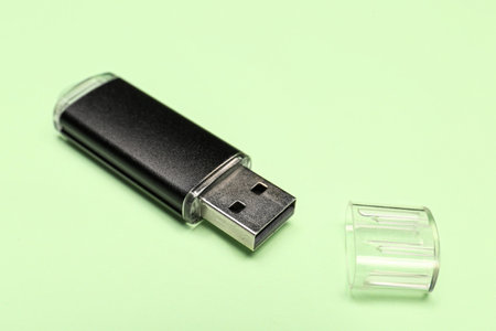 Black USB flash drive on green backgroundの写真素材