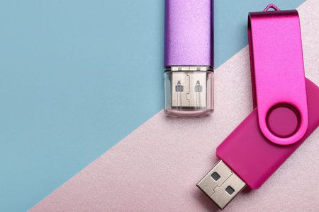 Colorful USB flash drives on color background