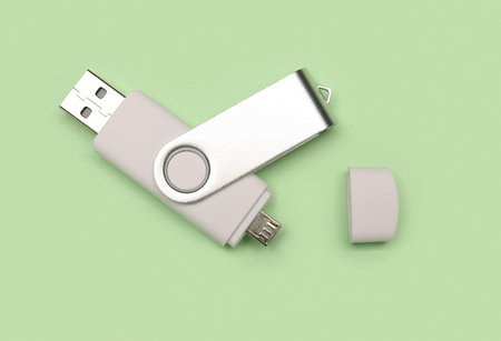 White USB flash drive on green background