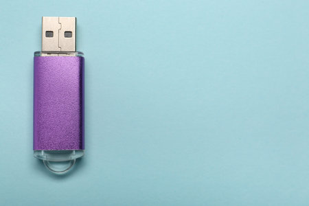 Purple USB flash drive on color backgroundの写真素材