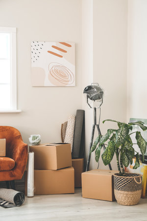 Cardboard boxes with accessories in new flat on moving dayの写真素材