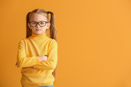 Cute little girl on color backgroundの写真素材