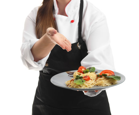 Young female chef with tasty dish on white backgroundの写真素材