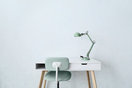 Table with lamp and chair in empty roomの写真素材