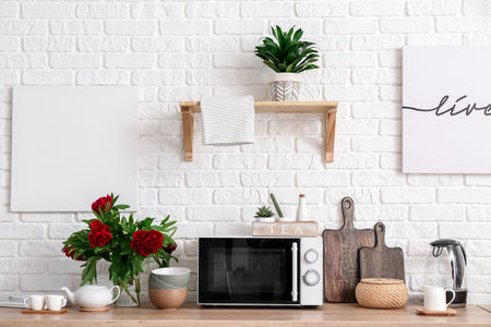 Set of utensils with microwave oven on kitchen counterの写真素材