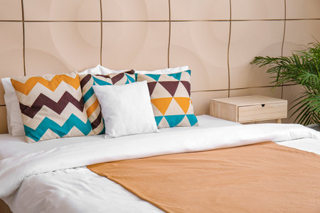 Big comfortable bed in hotel roomの写真素材