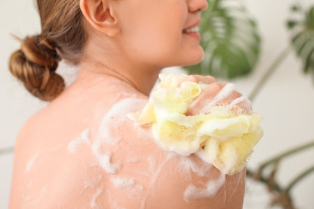 Beautiful young woman taking bath at homeの写真素材