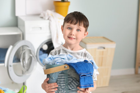 Little boy with dirty clothes at homeの写真素材