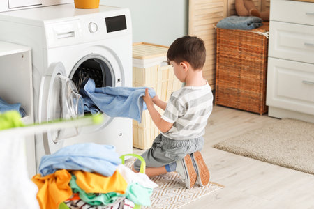 Little boy with dirty clothes at homeの写真素材