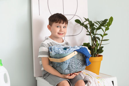 Little boy with dirty clothes at homeの写真素材