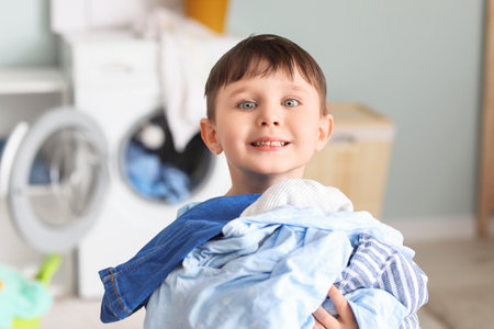 Little boy with dirty clothes at homeの写真素材