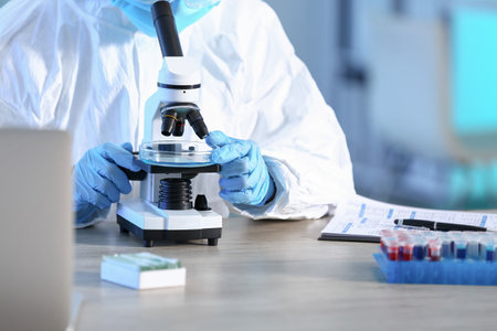 Scientist working with microscope in laboratoryの写真素材