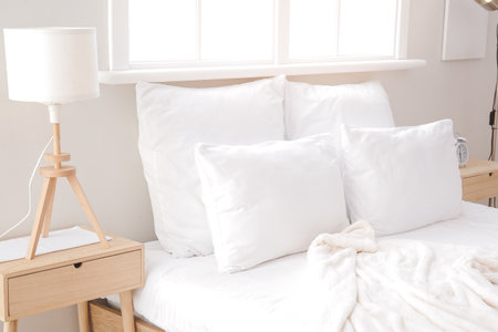 Big comfortable bed in hotel roomの写真素材