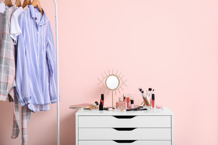 Set of makeup cosmetics with mirror on table in dressing roomの写真素材