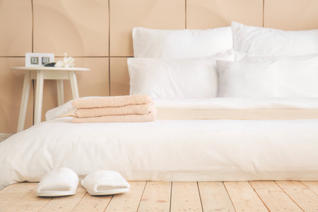 Big comfortable bed in hotel roomの写真素材