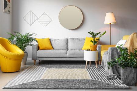 Stylish interior of living room with mirror and sofaの写真素材