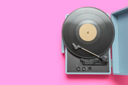 Record player with vinyl disk on pink backgroundの写真素材