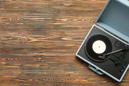 Record player with vinyl disk on wooden backgroundの写真素材