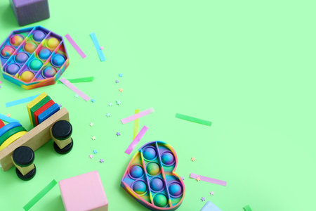 Toys with confetti on green background, closeup. Children's Day celebrationの写真素材