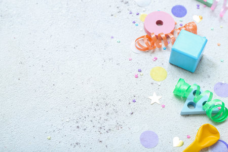 Baby toys with confetti on white background, closeup. Children's Day celebrationの写真素材