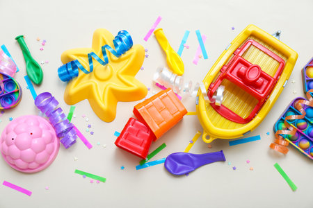 Baby toys with confetti and balloons on beige background. Children's Day celebrationの写真素材