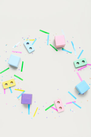Frame made of baby blocks and confetti on beige background. Children's Day celebrationの写真素材
