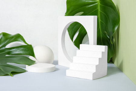 Plaster podiums and monstera leaves on green backgroundの写真素材