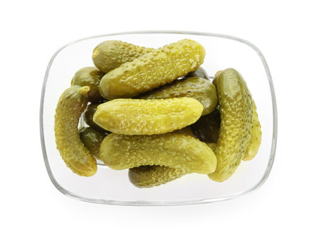 Bowl with tasty fermented cucumbers on white backgroundの写真素材