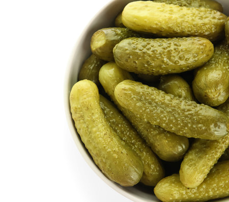 Bowl with tasty fermented cucumbers on white backgroundの写真素材