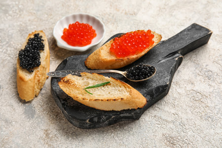 Tasty bruschettas with red and black caviar on grunge backgroundの写真素材