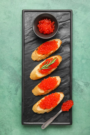 Tasty bruschettas with red caviar on green backgroundの写真素材