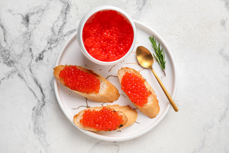 Tasty bruschettas with red caviar on grunge backgroundの写真素材