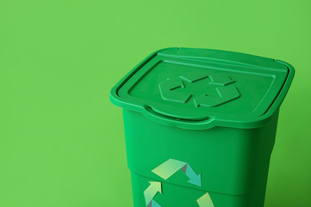 Container for garbage on green background. Recycling conceptの写真素材