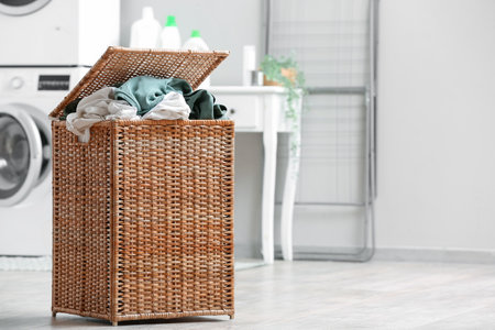 Basket with dirty clothes in laundry roomの写真素材