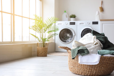 Basket with dirty clothes in laundry roomの写真素材